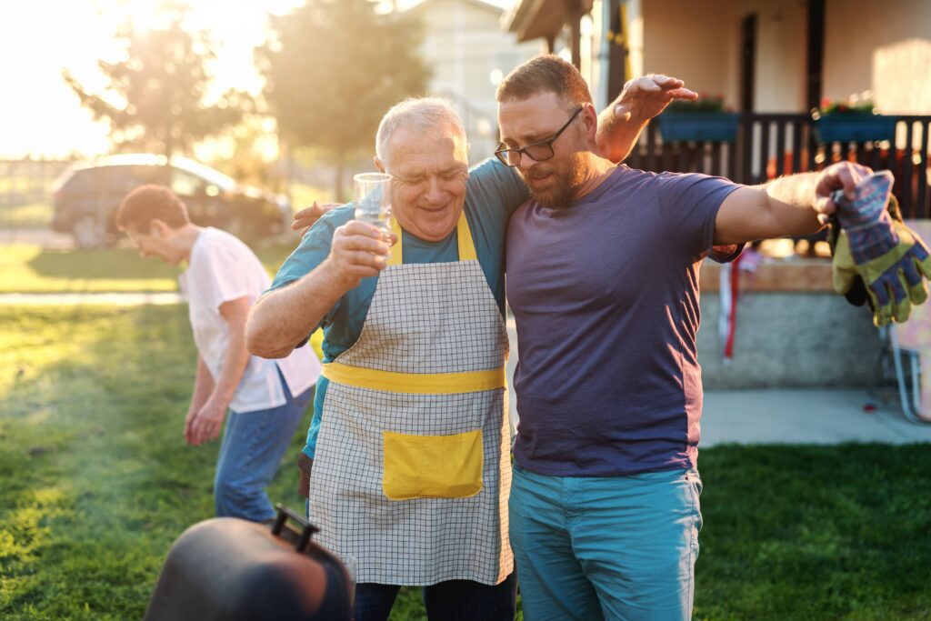 life area foojan app father in law tow men at a bbq side hugging