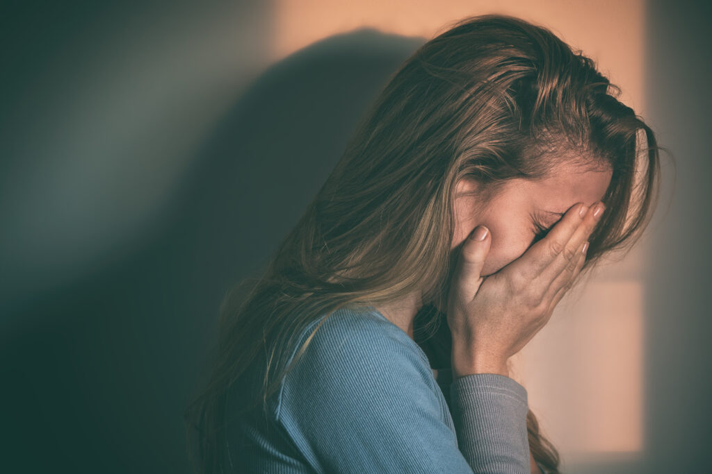 woman upset with face in her hands